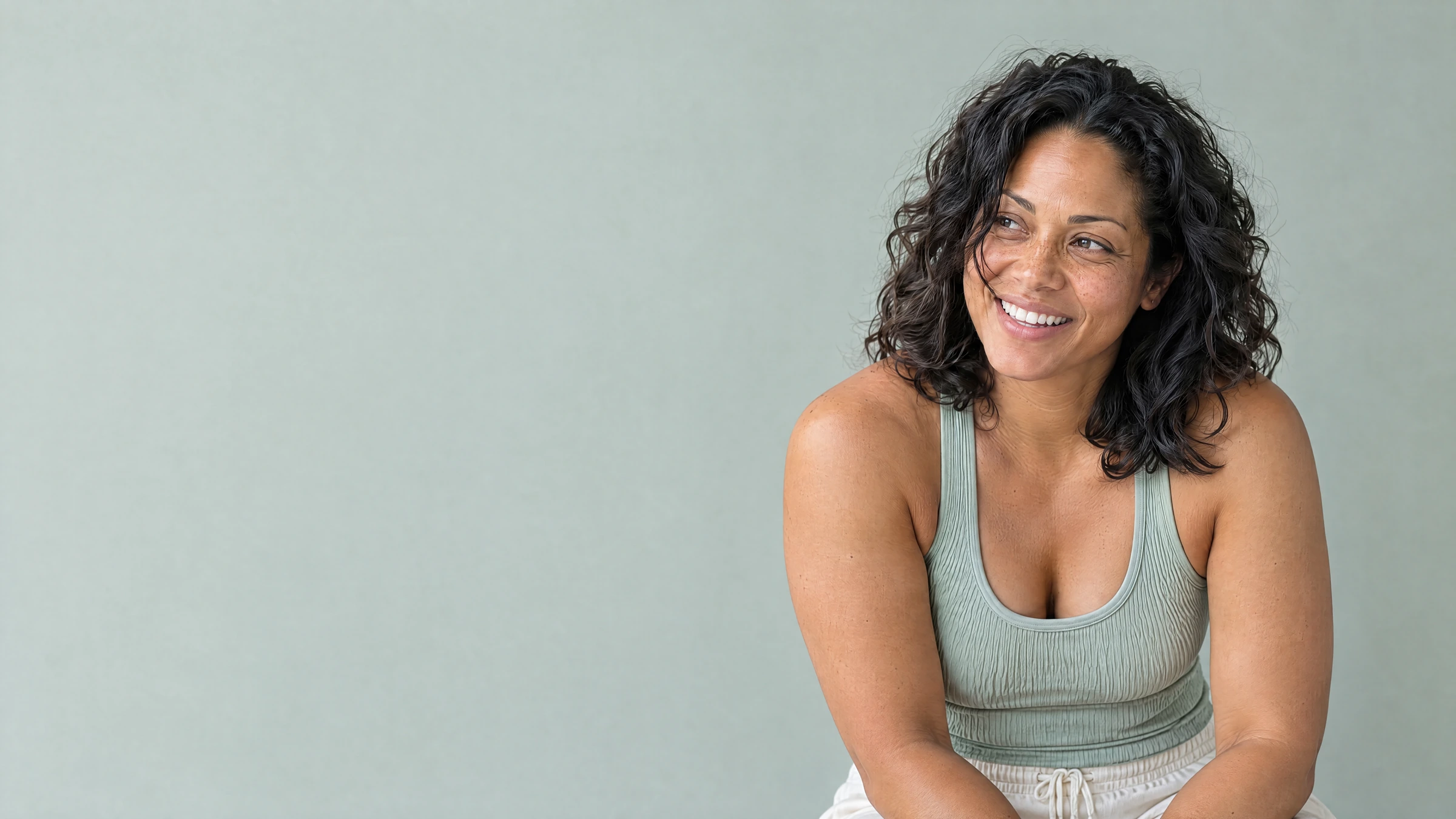 A woman smiling after exercise, framed with generous headroom